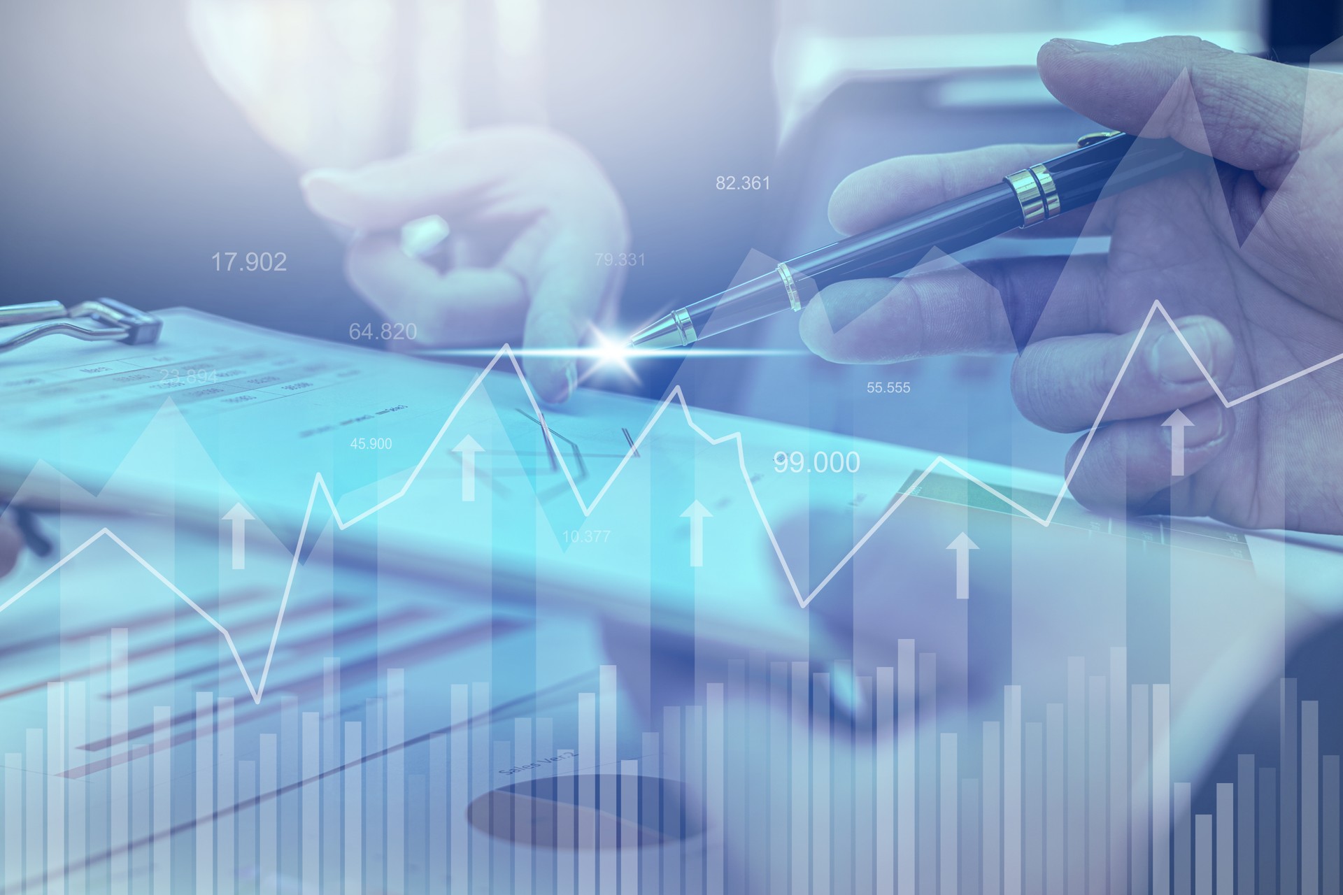 Two businessmen are meeting together, they point to financial documents to discuss plans and solutions, chart graphics showing financial status and performance. Business administration concept.